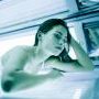 lady in tanning bed for UV tanning